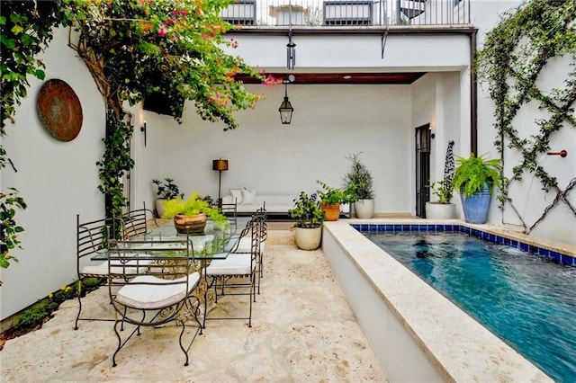 view of patio featuring outdoor dining space and an outdoor pool