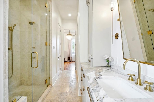 full bathroom with a shower stall, vanity, ensuite bathroom, and stone finish floor