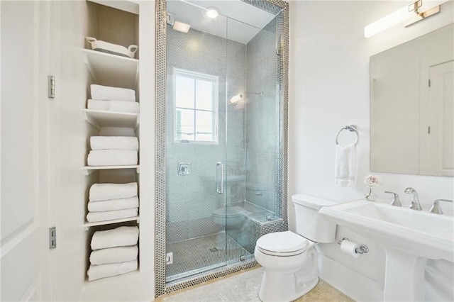 bathroom with toilet and an enclosed shower