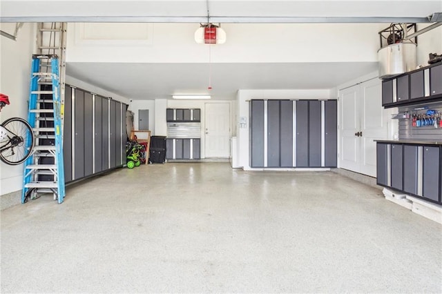 garage featuring electric panel and a garage door opener