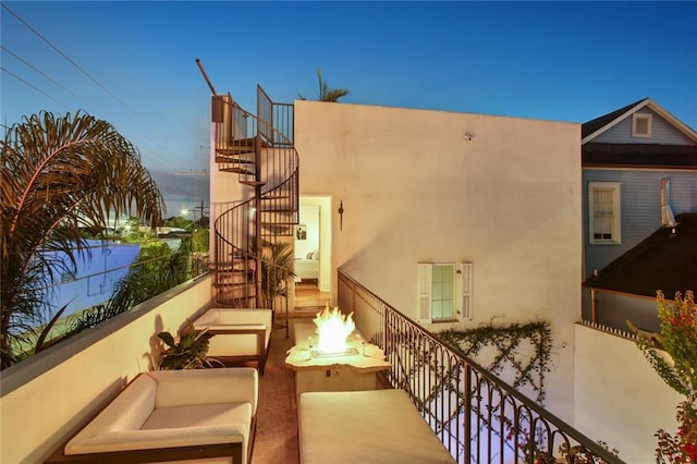 exterior space featuring an outdoor living space with a fire pit and stairway