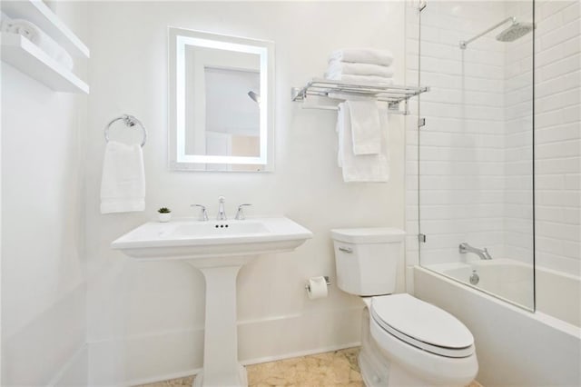 bathroom with toilet and tiled shower / bath combo