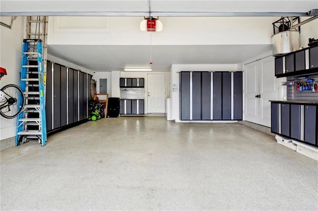 garage featuring electric panel and a garage door opener