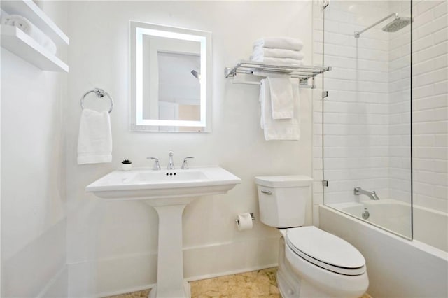 full bath featuring toilet, washtub / shower combination, and baseboards