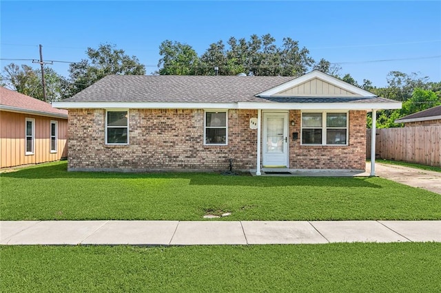 369 Pat Dr, Avondale, LA 70094 - ranch-style house with roof with shingles, a front yard, brick siding, and fence