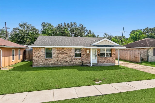 369 Pat Dr, Avondale, LA 70094 - ranch-style house featuring brick siding, a front yard, fence, and a shingled roof