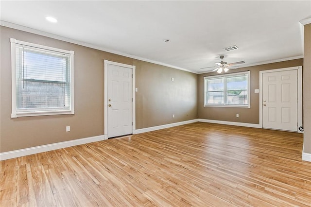 empty room featuring ornamental molding, light hardwood / wood-style flooring, and ceiling fan