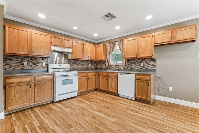 kitchen featuring white appliances, tasteful backsplash, ornamental molding, and light wood-type flooring