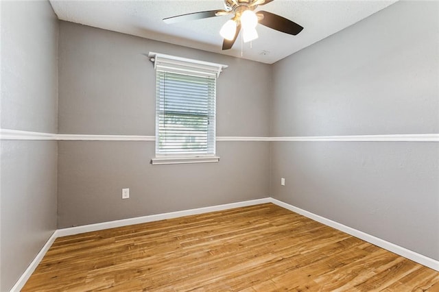 unfurnished room with wood-type flooring and ceiling fan