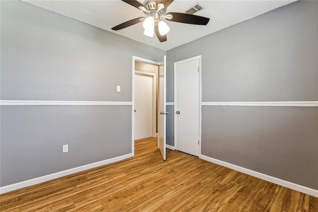 unfurnished bedroom featuring wood-type flooring and ceiling fan