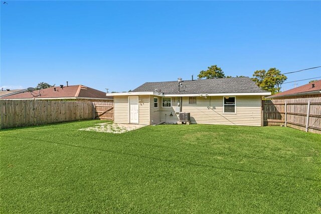 369 Pat Dr, Avondale, LA 70094 - back of house with central AC, a fenced backyard, and a lawn