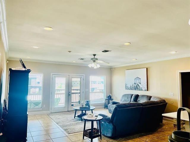 living room featuring ceiling fan, french doors, tile patterned flooring, and ornamental molding