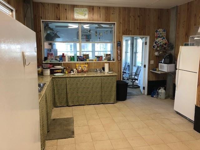 kitchen with wood walls and white appliances