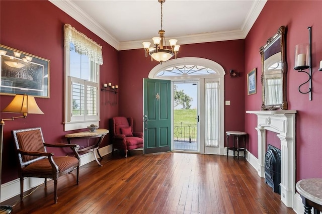 foyer entrance with a chandelier, crown molding, and dark hardwood / wood-style flooring