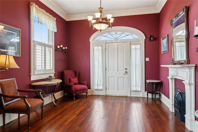 entryway featuring an inviting chandelier, crown molding, dark wood-type flooring, and a wealth of natural light