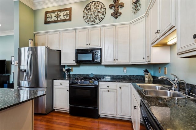 kitchen with dark hardwood / wood-style floors, black appliances, sink, and white cabinetry