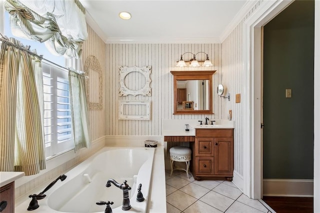 bathroom featuring tile patterned floors, a tub, crown molding, and vanity