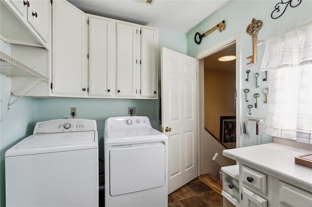 laundry room featuring cabinets and washing machine and dryer