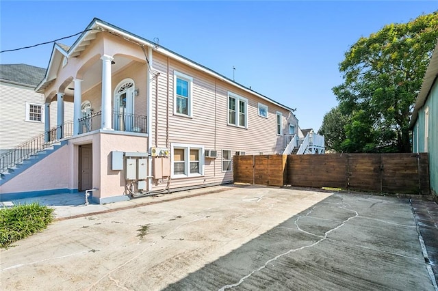 back of property featuring a balcony