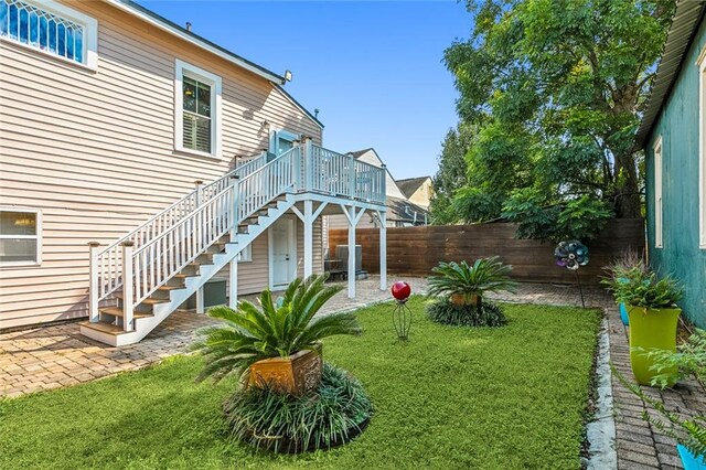 view of yard featuring a patio and a deck