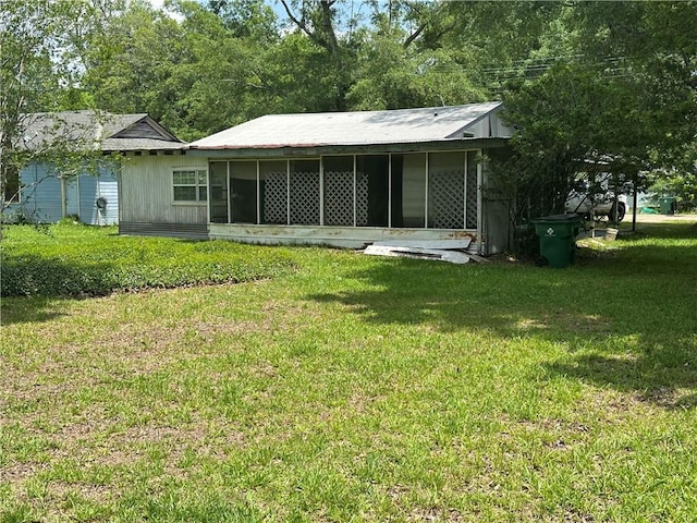 back of property featuring a lawn