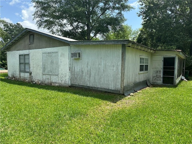 view of outbuilding featuring a lawn