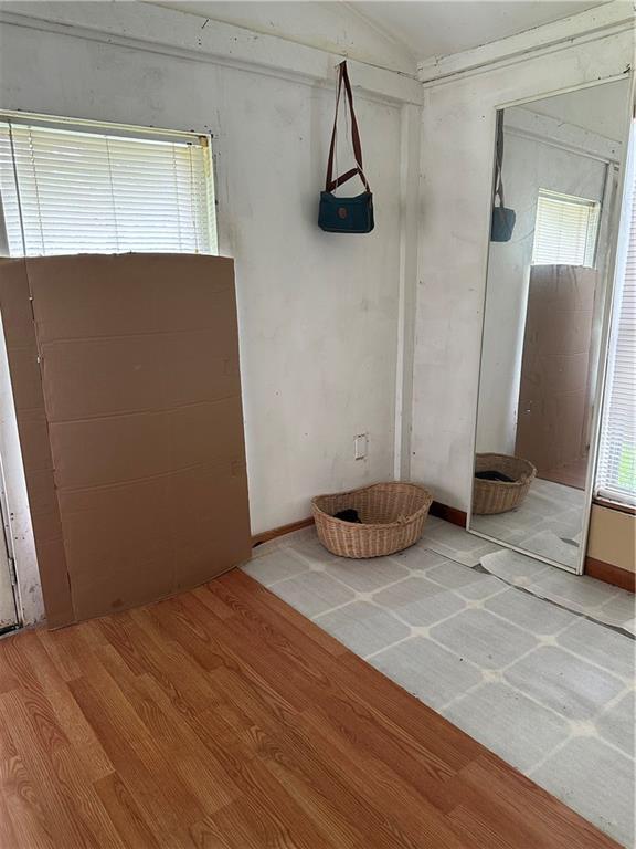 bathroom featuring hardwood / wood-style floors and vaulted ceiling