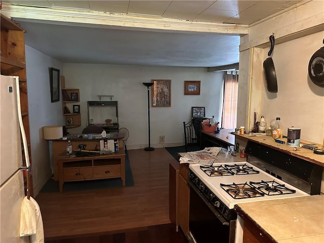 kitchen with range with gas cooktop, white refrigerator, and dark hardwood / wood-style flooring