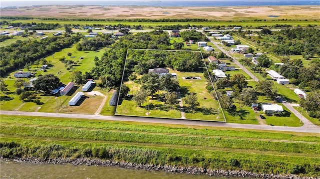 birds eye view of property with a rural view and a water view