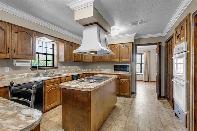 kitchen with a center island, double oven, electric cooktop, ornamental molding, and dishwasher