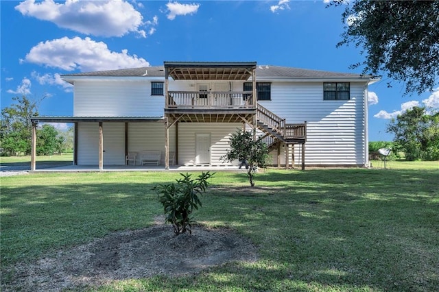 rear view of property with a yard and a patio area