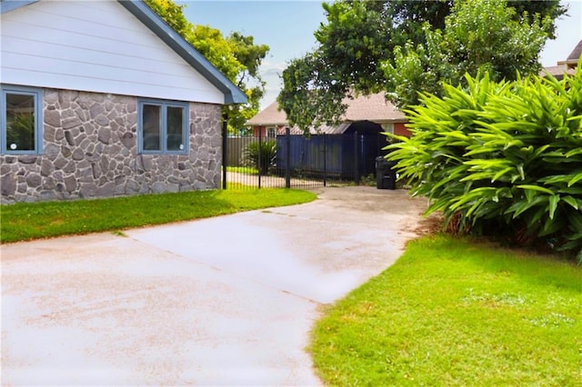 view of side of home featuring a lawn