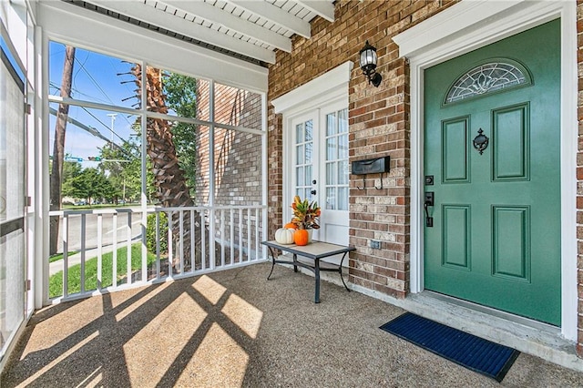 view of exterior entry with covered porch