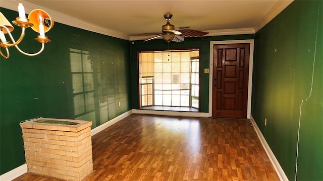 interior space with ceiling fan with notable chandelier, ornamental molding, and hardwood / wood-style flooring