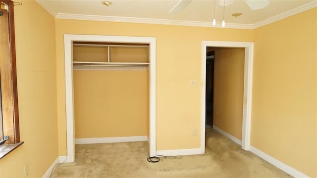 unfurnished bedroom with light carpet, a closet, crown molding, and ceiling fan