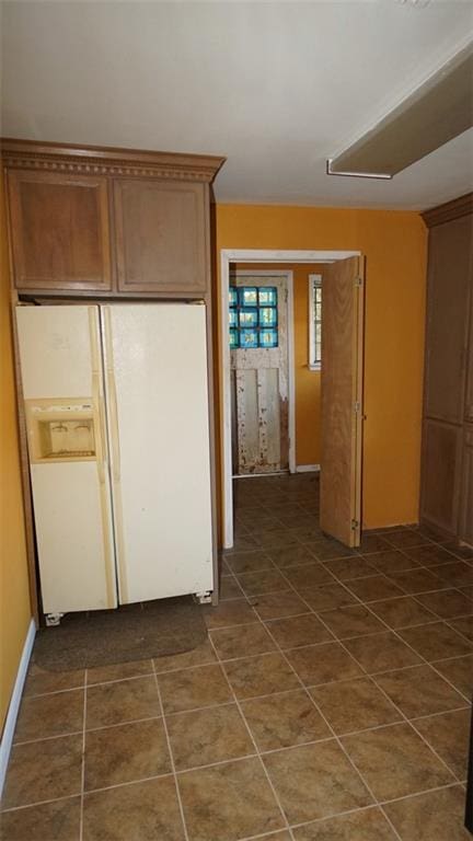 kitchen featuring white refrigerator with ice dispenser