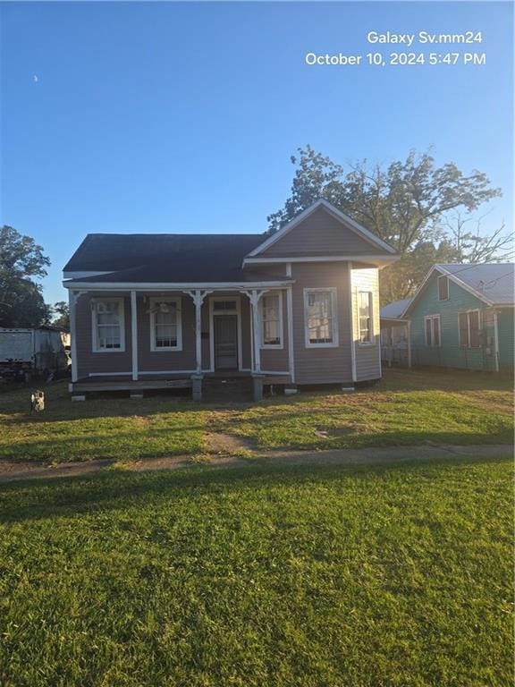 bungalow-style home with a front yard and a porch