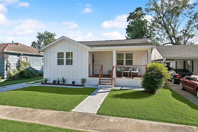 view of front of property with a front yard and covered porch