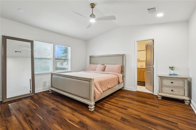 bedroom featuring ceiling fan, connected bathroom, dark hardwood / wood-style floors, and vaulted ceiling