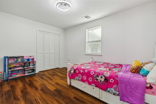 bedroom featuring a closet and dark hardwood / wood-style flooring