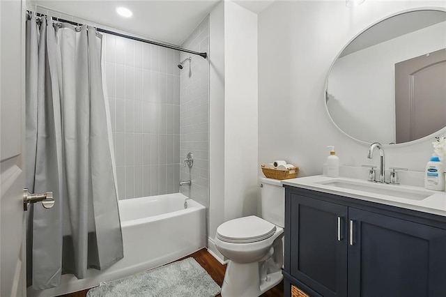 full bathroom with vanity, toilet, hardwood / wood-style flooring, and shower / bath combo