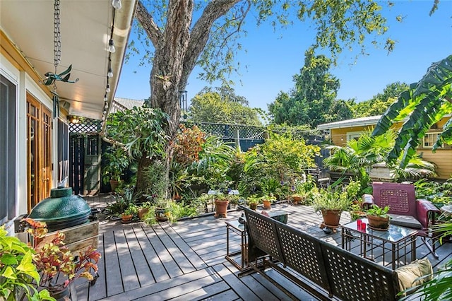 wooden terrace featuring fence and outdoor dining space