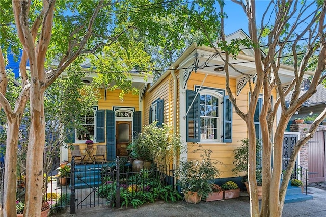 exterior space featuring a porch, fence, and a gate