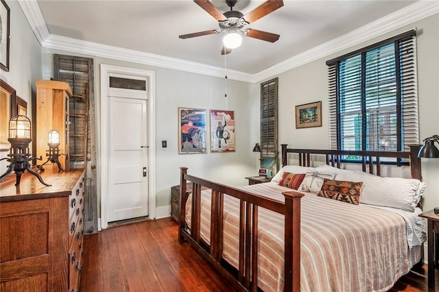 bedroom with dark wood-style floors, ceiling fan, baseboards, and crown molding