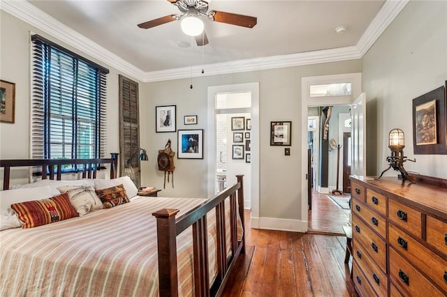 bedroom featuring baseboards, dark wood-type flooring, a ceiling fan, and crown molding