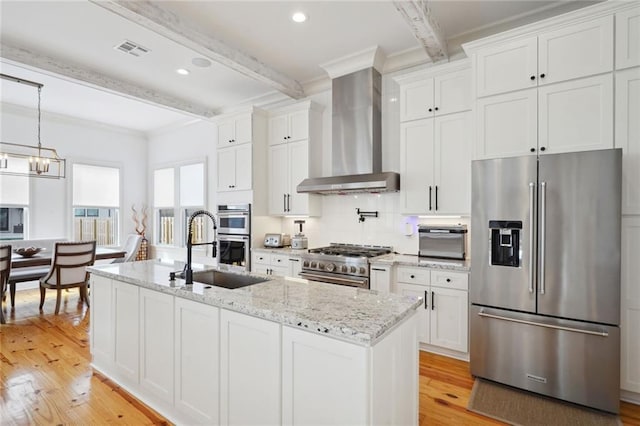 kitchen featuring high end appliances, visible vents, a sink, beamed ceiling, and wall chimney exhaust hood