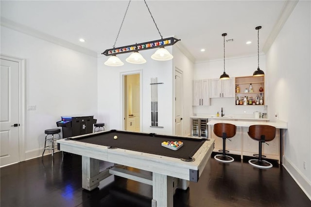 game room featuring indoor wet bar, pool table, baseboards, and dark wood-style flooring