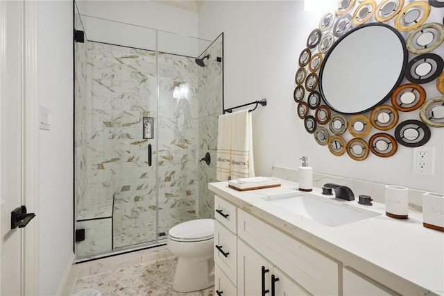 bathroom with a stall shower, toilet, and vanity