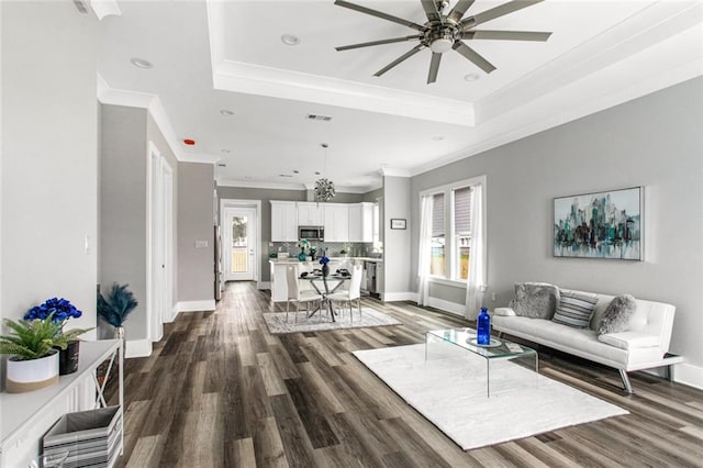 living room featuring ornamental molding, ceiling fan, and dark hardwood / wood-style flooring