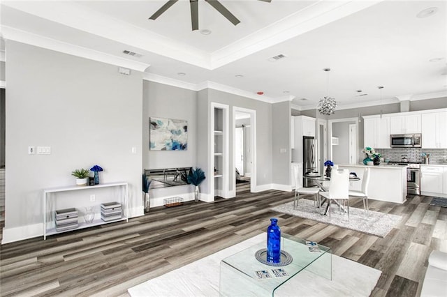 living room featuring ornamental molding, ceiling fan, and dark hardwood / wood-style flooring